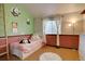 bedroom with twin bed, bamboo decal, wood floors, and natural light at 20113 Edinborough Ct, Parker, CO 80138