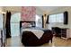 Bright bedroom with arched window, hardwood floors, and modern decor at 20113 Edinborough Ct, Parker, CO 80138