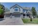 Charming two-story home with a three-car garage, well-manicured lawn, and inviting front porch at 20113 Edinborough Ct, Parker, CO 80138
