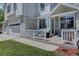 Inviting covered front porch with a seating area, fresh landscaping, and plenty of natural light at 20113 Edinborough Ct, Parker, CO 80138