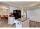 Eat-in kitchen view including island, pantry storage, and dining room visible in background at 20113 Edinborough Ct, Parker, CO 80138