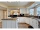 Modern kitchen features white cabinets, an island with granite countertops, and stainless steel appliances at 20113 Edinborough Ct, Parker, CO 80138