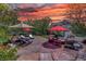 Expansive stamped concrete patio with an outdoor seating area, umbrellas, and lush landscaping at 20113 Edinborough Ct, Parker, CO 80138