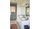 Bright bathroom with double vanity, modern lighting, and a glass-enclosed shower at 701 E 24Th Ave, Denver, CO 80205