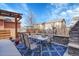 Backyard patio features a dining set with a stone fireplace and outdoor seating at 1628 Taos St, Brighton, CO 80603