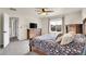 Bedroom with a beautiful patterned duvet, dresser, TV and an abundance of natural light at 1628 Taos St, Brighton, CO 80603