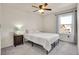 Cozy bedroom featuring a queen-size bed, ceiling fan and a window providing natural light at 1628 Taos St, Brighton, CO 80603