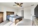 Sun-drenched bedroom showcases a wooden bed frame, cozy decor, and comfortable carpet at 1628 Taos St, Brighton, CO 80603