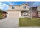 Charming two-story home with a well-manicured lawn and an attached two-car garage at 1628 Taos St, Brighton, CO 80603