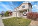 Beautiful home featuring a green lawn, mature landscaping, and a welcoming covered front porch at 1628 Taos St, Brighton, CO 80603