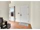 Bright foyer featuring hardwood floors, a white front door, and a large window at 1628 Taos St, Brighton, CO 80603