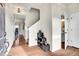 Bright entryway with hardwood floors, staircase, and convenient access to a half bathroom at 1628 Taos St, Brighton, CO 80603