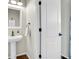 Stylish half bathroom featuring a modern pedestal sink and updated fixtures at 1628 Taos St, Brighton, CO 80603