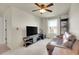 Comfortable living room featuring a large TV, plush carpet, and a brown leather couch at 1628 Taos St, Brighton, CO 80603