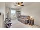 Cozy living room with plush carpet, fan, and lots of natural light from the window at 1628 Taos St, Brighton, CO 80603