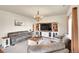 Bright living room features comfortable seating, an entertainment center, and a wooden chandelier at 1628 Taos St, Brighton, CO 80603