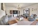Cozy living room with plush seating, an entertainment center, a wooden chandelier, and a large window at 1628 Taos St, Brighton, CO 80603