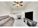 Spacious living room with a soft carpet, media center, and a view of an open hallway at 1628 Taos St, Brighton, CO 80603