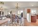 Open-concept living and dining area with hardwood floors and ample natural light at 1628 Taos St, Brighton, CO 80603