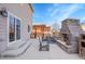 Spacious outdoor patio featuring a stone fireplace, dining set, and access to the home via sliding glass doors at 1628 Taos St, Brighton, CO 80603