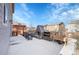 Expansive patio with a stone fireplace, outdoor kitchen area, dining set, and easy access to the house at 1628 Taos St, Brighton, CO 80603