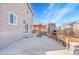 Wide angle of outdoor patio with stone fireplace, dining set, outdoor access and exterior of the home at 1628 Taos St, Brighton, CO 80603