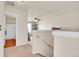 Upstairs hallway with carpet flooring, access to a bathroom, and a view of an upstairs room at 1628 Taos St, Brighton, CO 80603