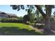 Expansive backyard with green grass, flowers, and a charming wooden cart detail at 164 W Acoma Dr, Littleton, CO 80120