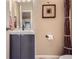 Powder room featuring a sleek vanity, a decorative mirror, and modern fixtures at 164 W Acoma Dr, Littleton, CO 80120