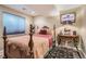 Cozy bedroom featuring a unique bedframe, decorative side table and patterned rug at 164 W Acoma Dr, Littleton, CO 80120