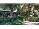 Charming home with a beautifully landscaped front yard, mature trees, and a cozy porch at 164 W Acoma Dr, Littleton, CO 80120