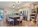 Open kitchen featuring an island with barstool seating, stainless steel appliances, and custom cabinetry at 164 W Acoma Dr, Littleton, CO 80120