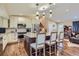 Bright kitchen boasting a center island with seating, stainless steel appliances, and ample counter space at 164 W Acoma Dr, Littleton, CO 80120