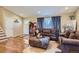Cozy living room featuring hardwood floors, comfortable seating, and natural light from the window at 164 W Acoma Dr, Littleton, CO 80120