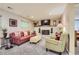 Cozy living room featuring a brick fireplace, plush seating, and neutral decor at 164 W Acoma Dr, Littleton, CO 80120