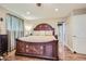 Bedroom with hardwood floors, a large decorative bed frame, and ample closet space at 164 W Acoma Dr, Littleton, CO 80120