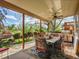 Spacious covered patio with a built-in outdoor kitchen, dining area, and views of the beautifully landscaped backyard at 164 W Acoma Dr, Littleton, CO 80120
