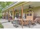 Inviting covered patio featuring comfortable seating, ceiling fans, stylish decor, and an outdoor grill for relaxing entertainment at 164 W Acoma Dr, Littleton, CO 80120