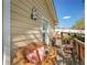 Charming outdoor seating area on the porch featuring wicker furniture, colorful cushions, and a vintage-style outdoor lantern at 164 W Acoma Dr, Littleton, CO 80120
