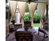 Cozy covered patio featuring comfortable seating, ceiling fan, and elegant curtains for privacy and shade at 164 W Acoma Dr, Littleton, CO 80120