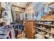 Spacious walk-in closet with wooden shelves, shoe racks, and drawers for maximum storage at 164 W Acoma Dr, Littleton, CO 80120