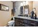 Bathroom with granite countertop vanity and a large, framed mirror at 1642 S Trenton St, Denver, CO 80231