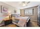 Cozy bedroom featuring a comfortable bed, a ceiling fan, and natural light from a window at 1642 S Trenton St, Denver, CO 80231