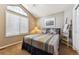 Bright bedroom with vaulted ceiling and a large window providing natural light and comfortable vibe at 1642 S Trenton St, Denver, CO 80231