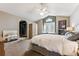 Bright bedroom with a ceiling fan, a large bed, and an arched doorway to the closet at 1642 S Trenton St, Denver, CO 80231