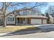 Charming two-story home with a brick facade and a three-car garage at 1642 S Trenton St, Denver, CO 80231