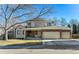 Charming two-story home with a brick facade and a three-car garage at 1642 S Trenton St, Denver, CO 80231