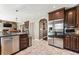 Spacious kitchen with stainless steel appliances, dark cabinets, and tiled flooring at 1642 S Trenton St, Denver, CO 80231