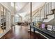 Elegant foyer with hardwood floors and a staircase leading to a spacious living room at 1642 S Trenton St, Denver, CO 80231