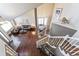 Upstairs view of a living room featuring hardwood floors and vaulted ceilings at 1642 S Trenton St, Denver, CO 80231